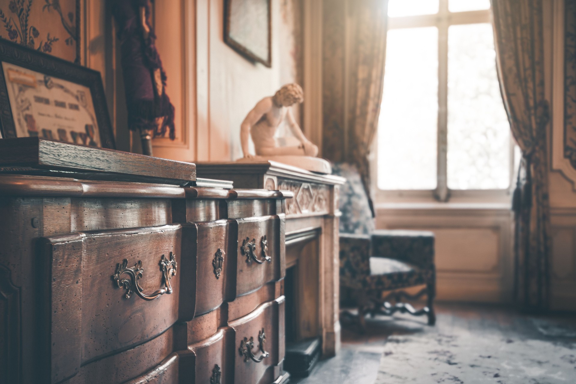 Interior of a vintage and old room with wooden dresser in selective focus