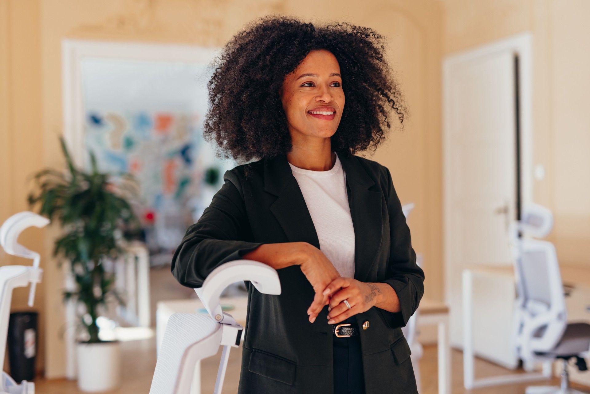 Confident businesswoman smiling and looking away in modern office